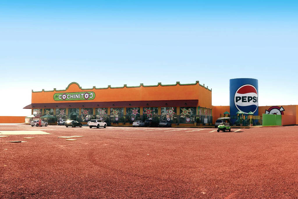 Image shows the exterior of a Los Cochinitos restaurant in Mexico.