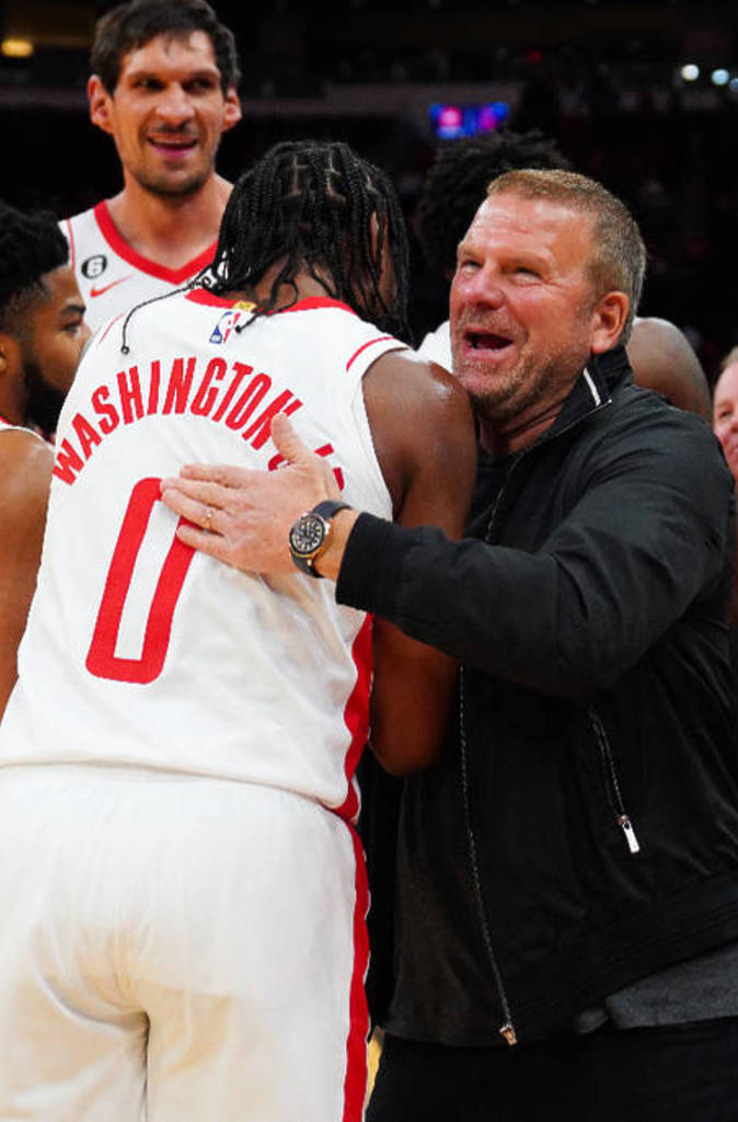 Image shows Rockets' owner Tilman Fertitta congratulating Rockets players.