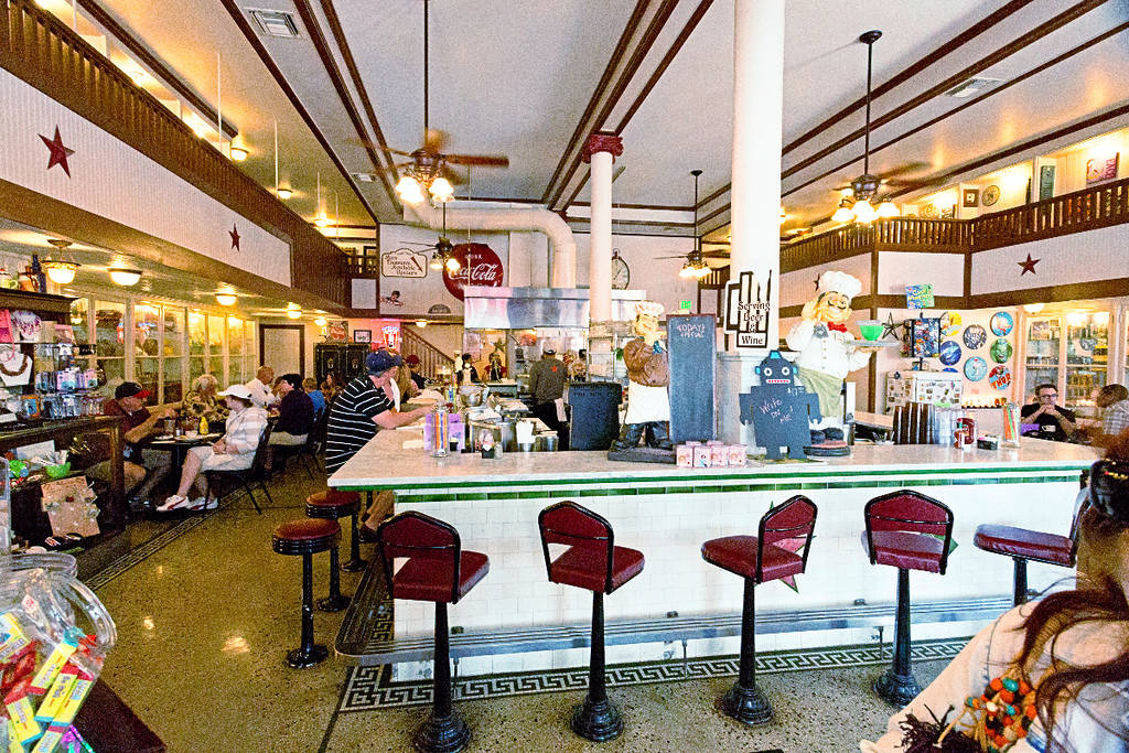 Image shows the soda fountain counter inside at Star Drug Store in Galveston, Texas.