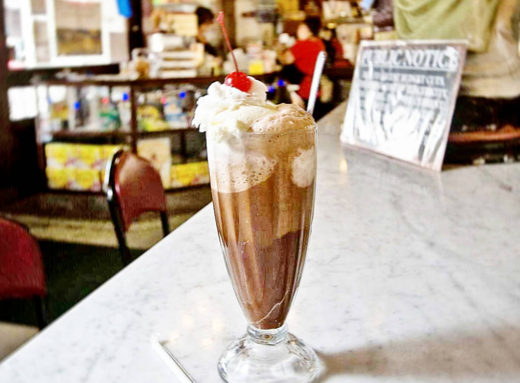 Image shows a milkshake on the counter of Star Drug Store in Galveston, Texas.