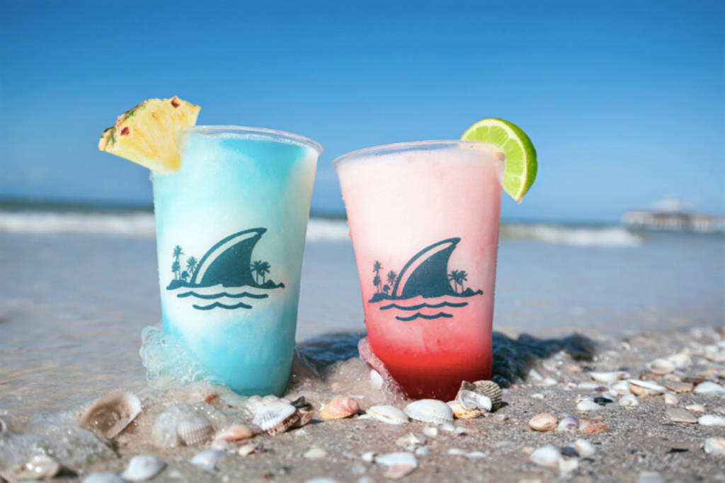 Image shows two frozen cocktail drinks with the Margaritaville logos.