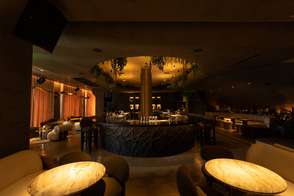 Image shows the moody interior of IIII cocktail lounge in Houston.