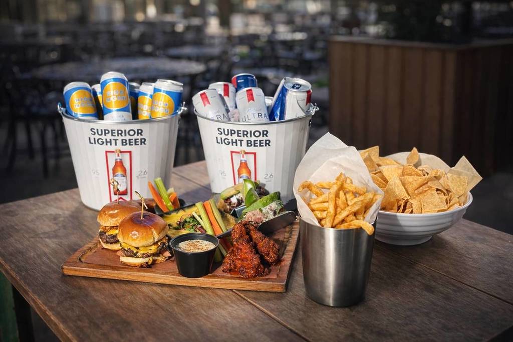 Image shows a tray of food and buckets of drinks. 