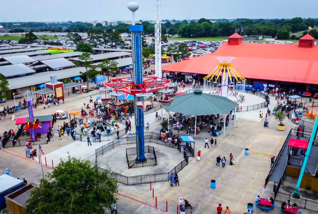 La imagen muestra las atracciones y el ambiente de Traders Village Houston. 
