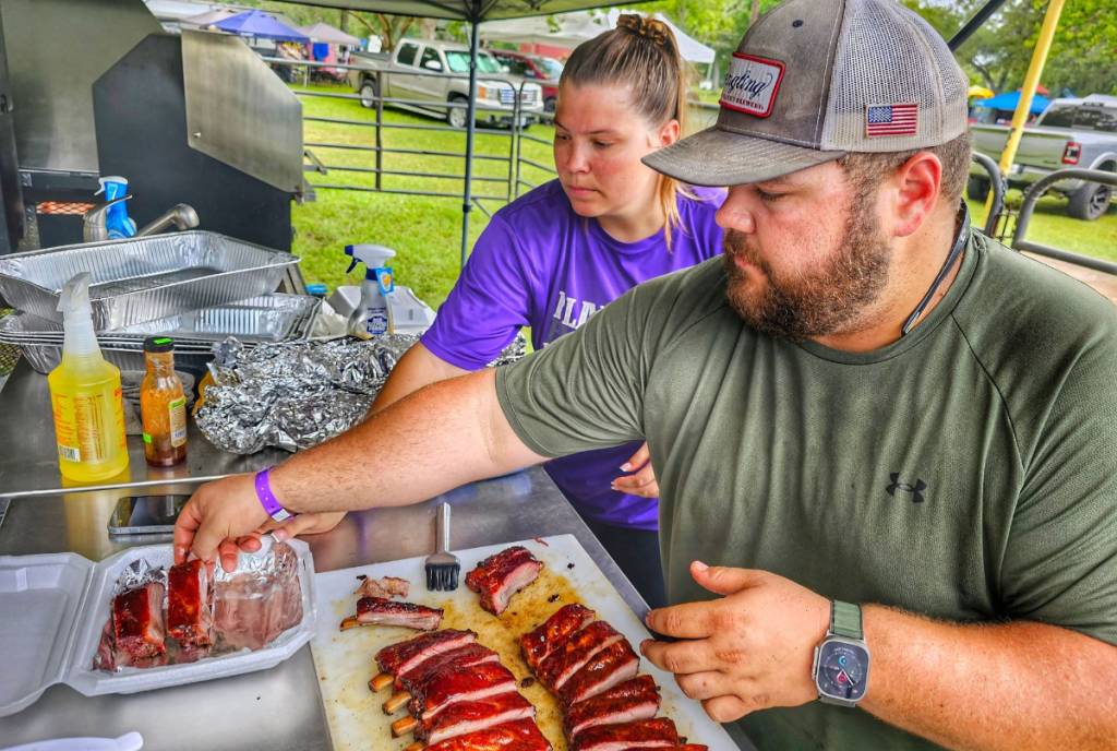Image shows guests preparing an American meal at Great Texas Mosquito Festival. 