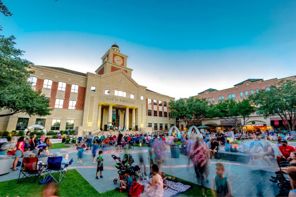 La imagen muestra la plaza de Sugar Land durante un evento. 