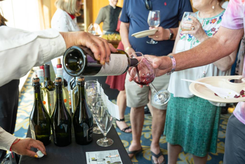 Image shows visitors attending the Galveston Island Wine Festival. 