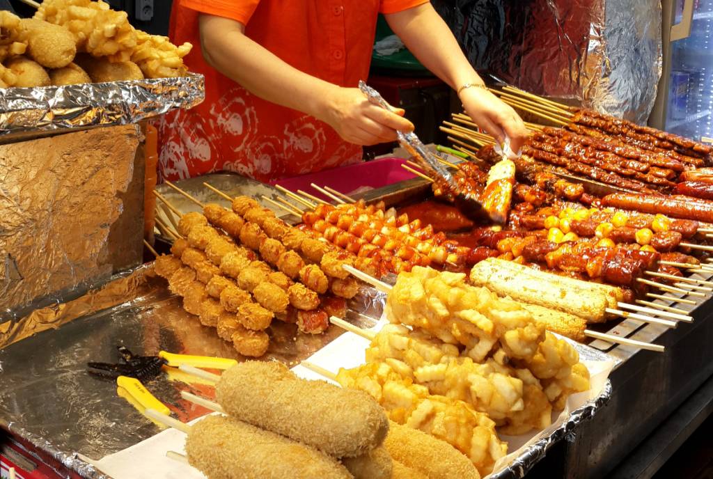 Image shows Asian street food.