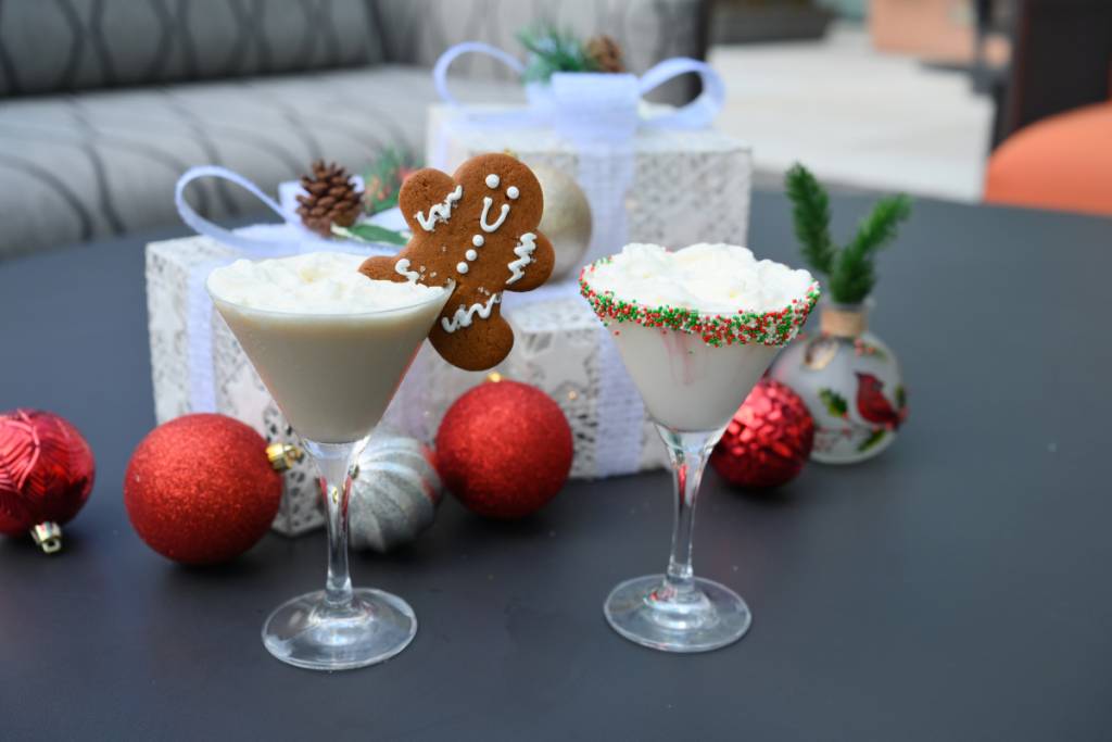 Image shows cocktails with a gingerbread man garnish. 