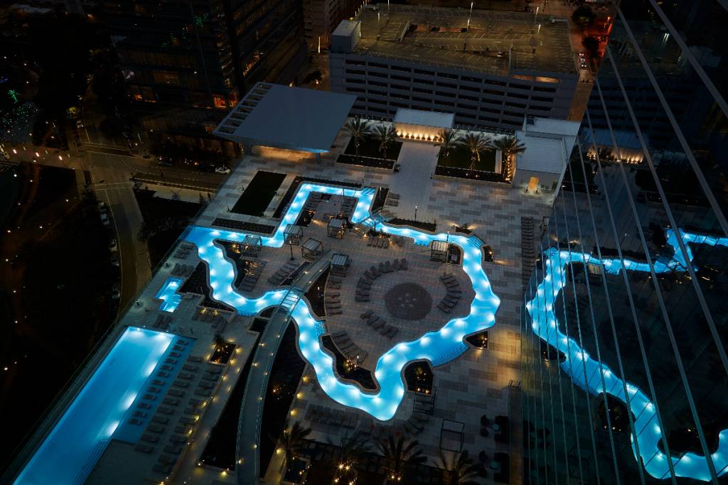 Image shows the Texas-shaped lazy river at Marriot Marquis Houston at night. 