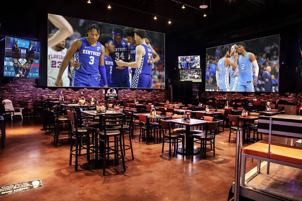 inside of a sports bar with multiple screens in Vegas