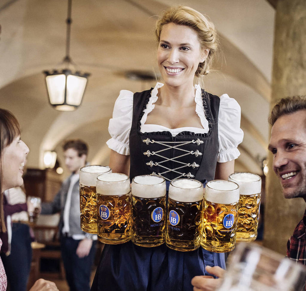 woman bringing beers at Oktoberfest table
