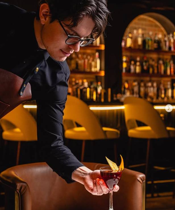 man serving cocktail