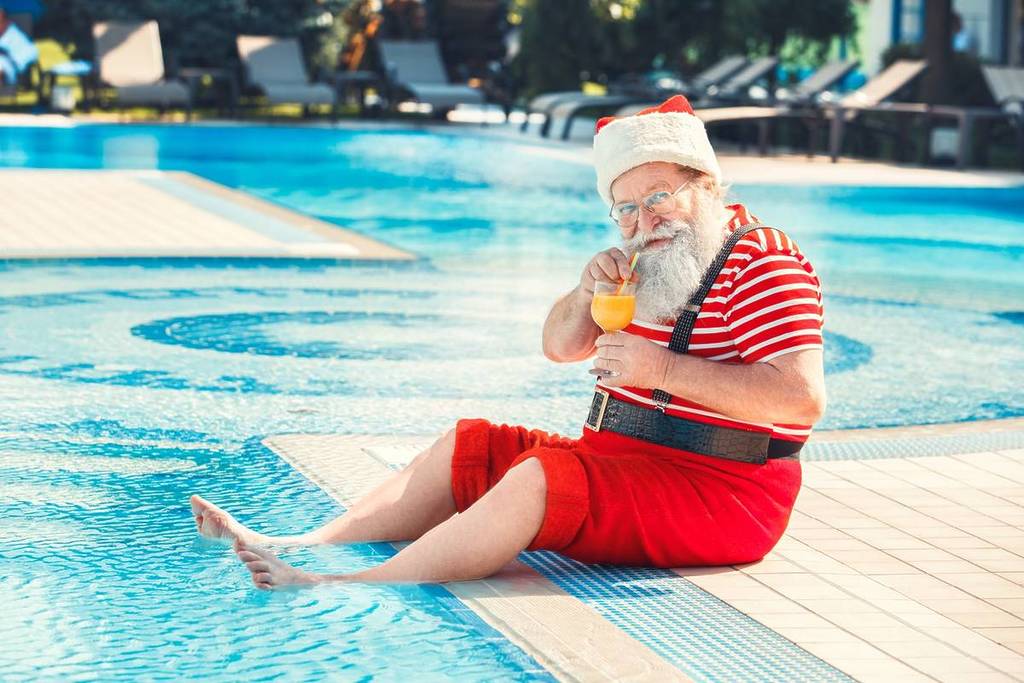 man dressed as Santa at Christmas pool party