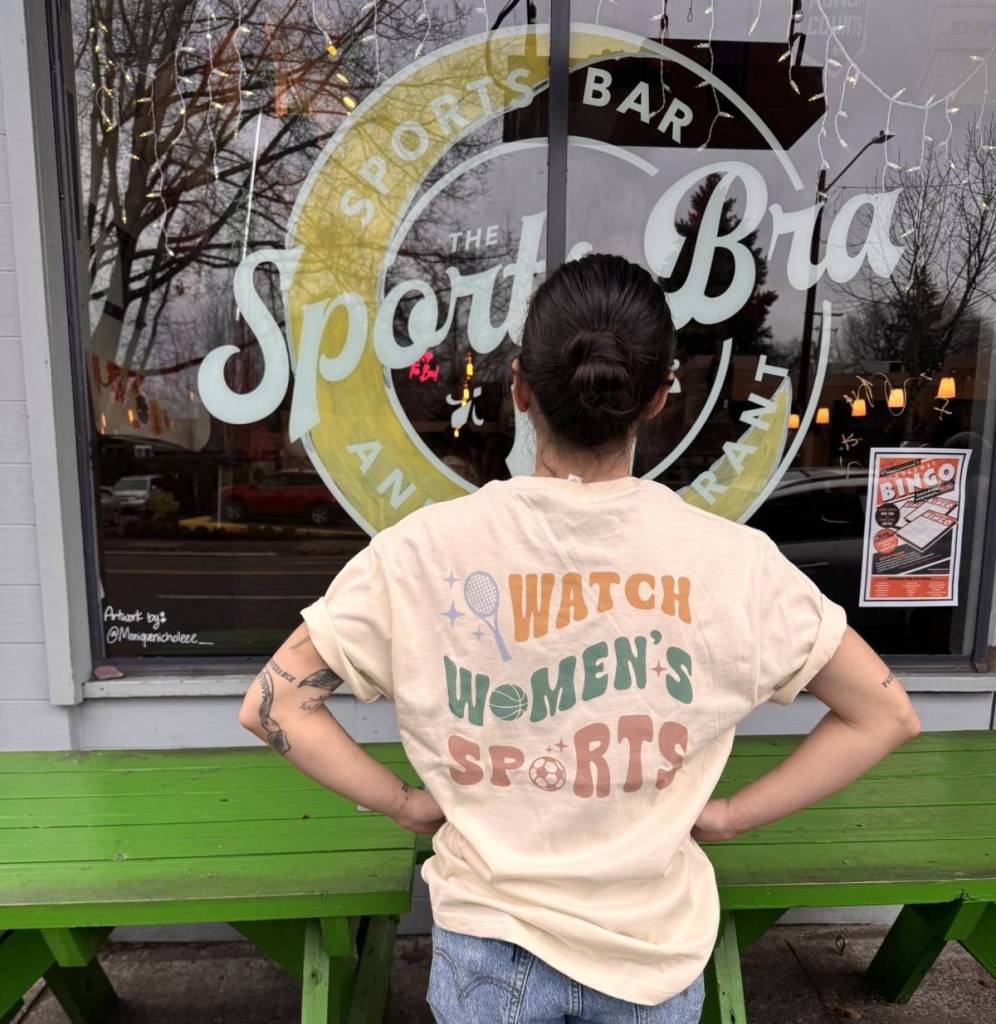 woman wearing a t-shirt that says 'watch women's sports'