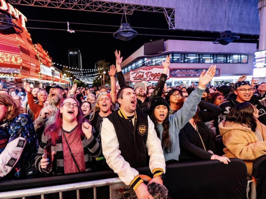 people singing along at an outdoor festival 