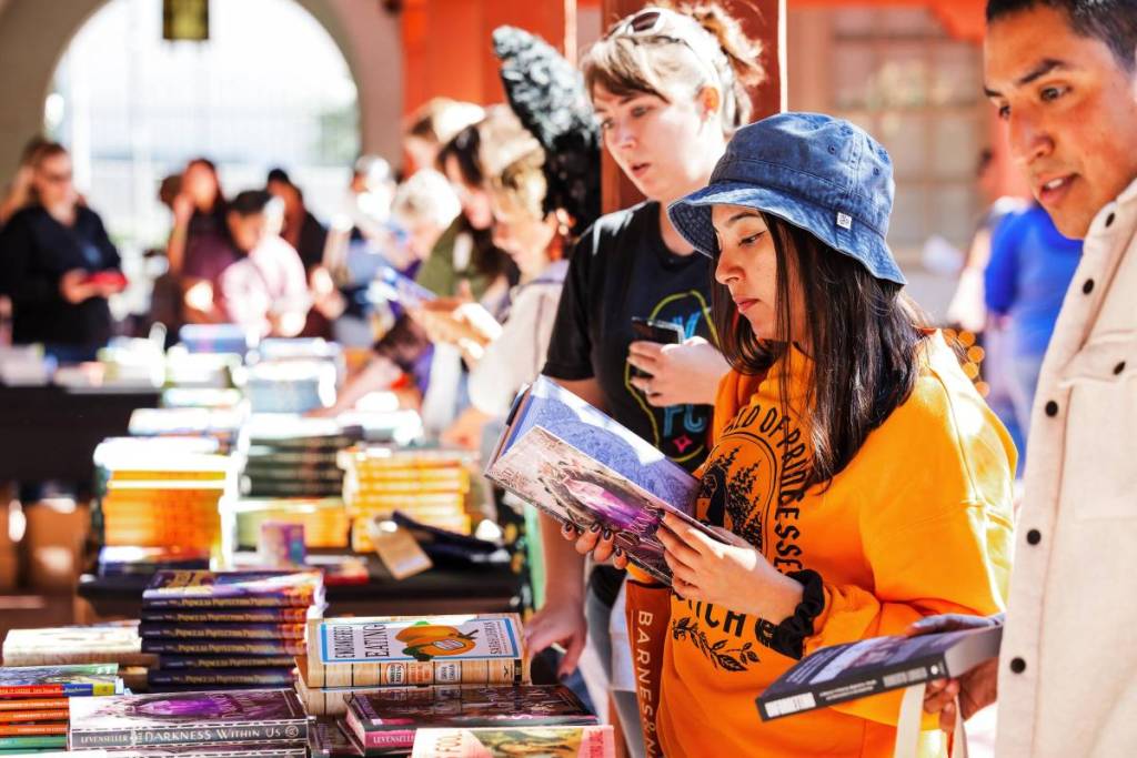 girl checking out a book