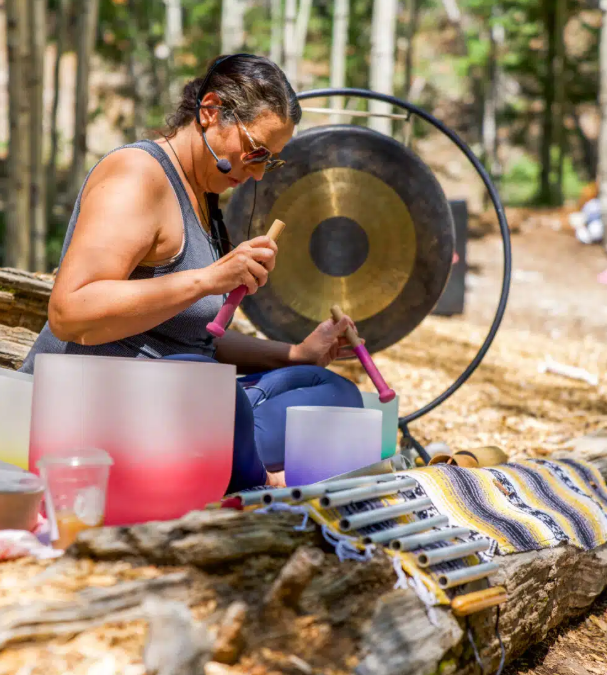 a woman performing a sound healing session