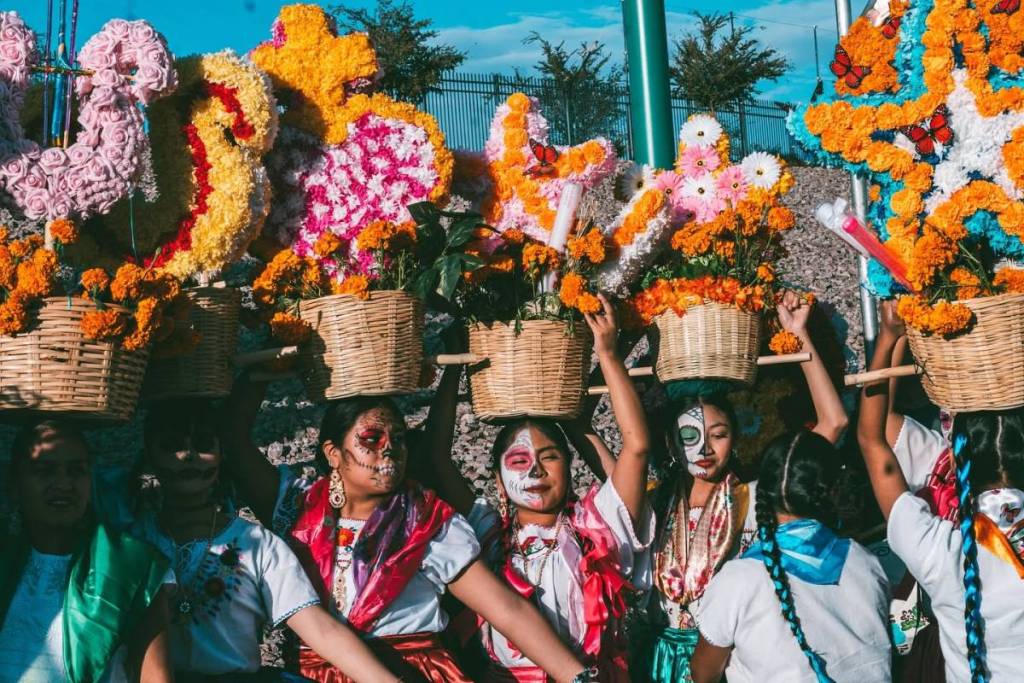 women dressed up with traditional Mexican face paint