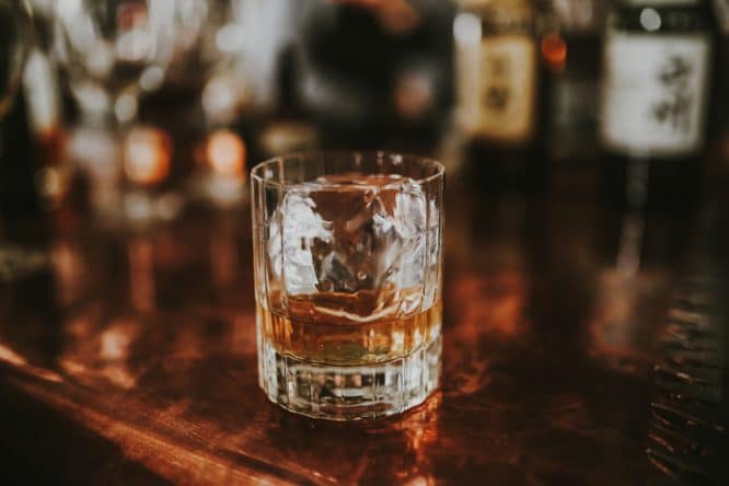 A glass of whiskey waiting to be drunk at a whiskey bar, one of the best stag do ideas in London