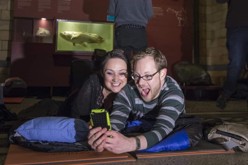 two guests taking a selfie at the Dino Snores event in the evening