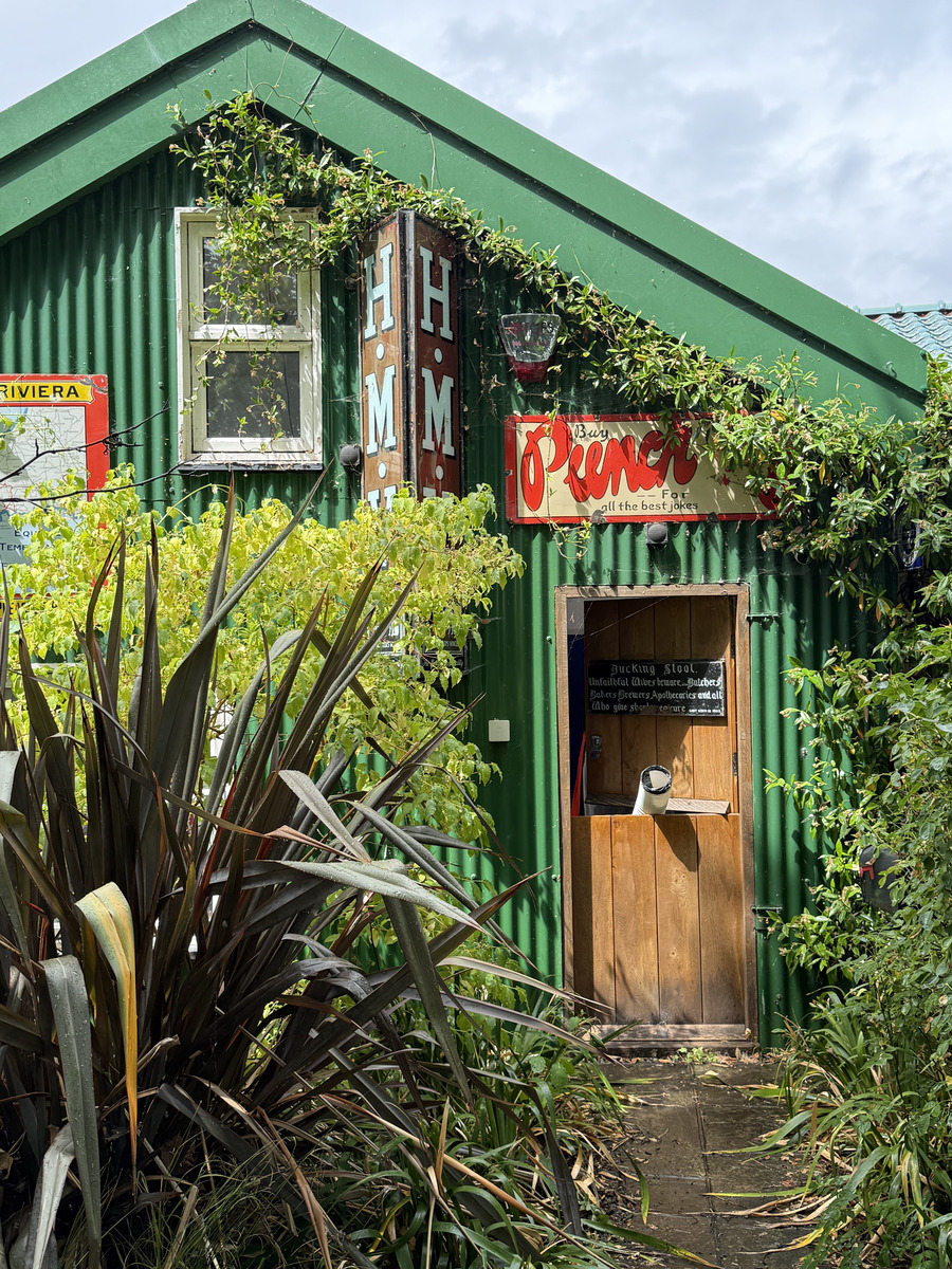 a bright green building in the sunshine on eel pie island