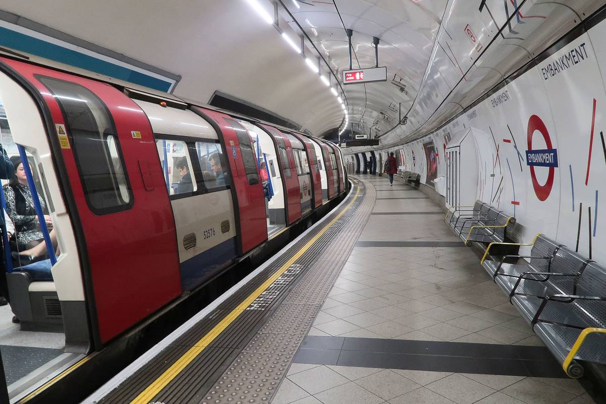 Embankment metro platform in London, with a metro train waiting for departure