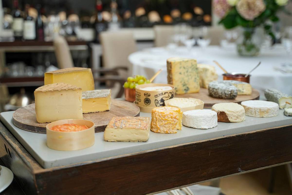 a whopping selection of countless varieties of cheese on a cheese trolley