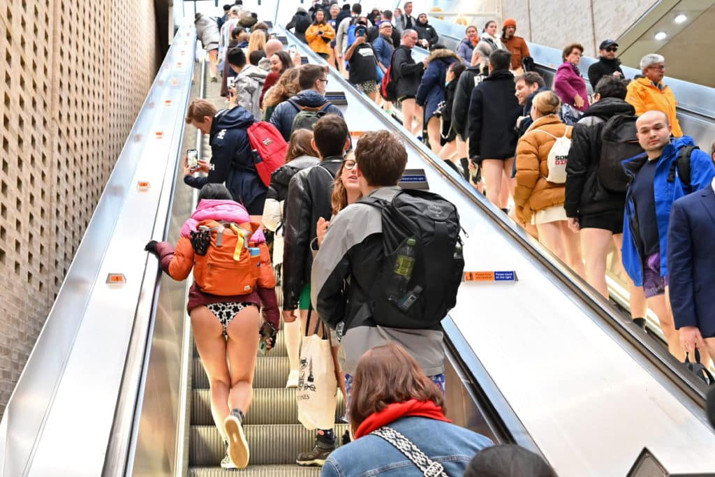 People take part in the annual 'No Trousers On The Tube Day' (No Pants Subway Ride), walking up the escalator, on the London Underground in central London on January 8, 2023