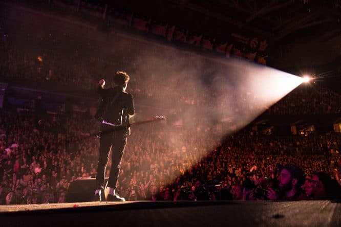 A singer performing to a crowd at a gig
