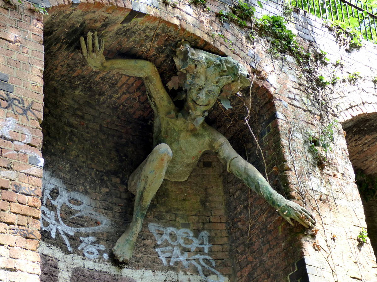 a statue of a Cornish sprite, or Spriggan, looming out from an alcove