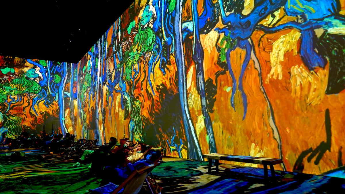 splatters of colour and abstract shapes all over the wall at the van gogh experience