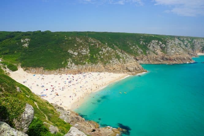 Turquoise waters and white sands at Porthcurno Beach in Western Cornwall, one of the best beaches in the UK