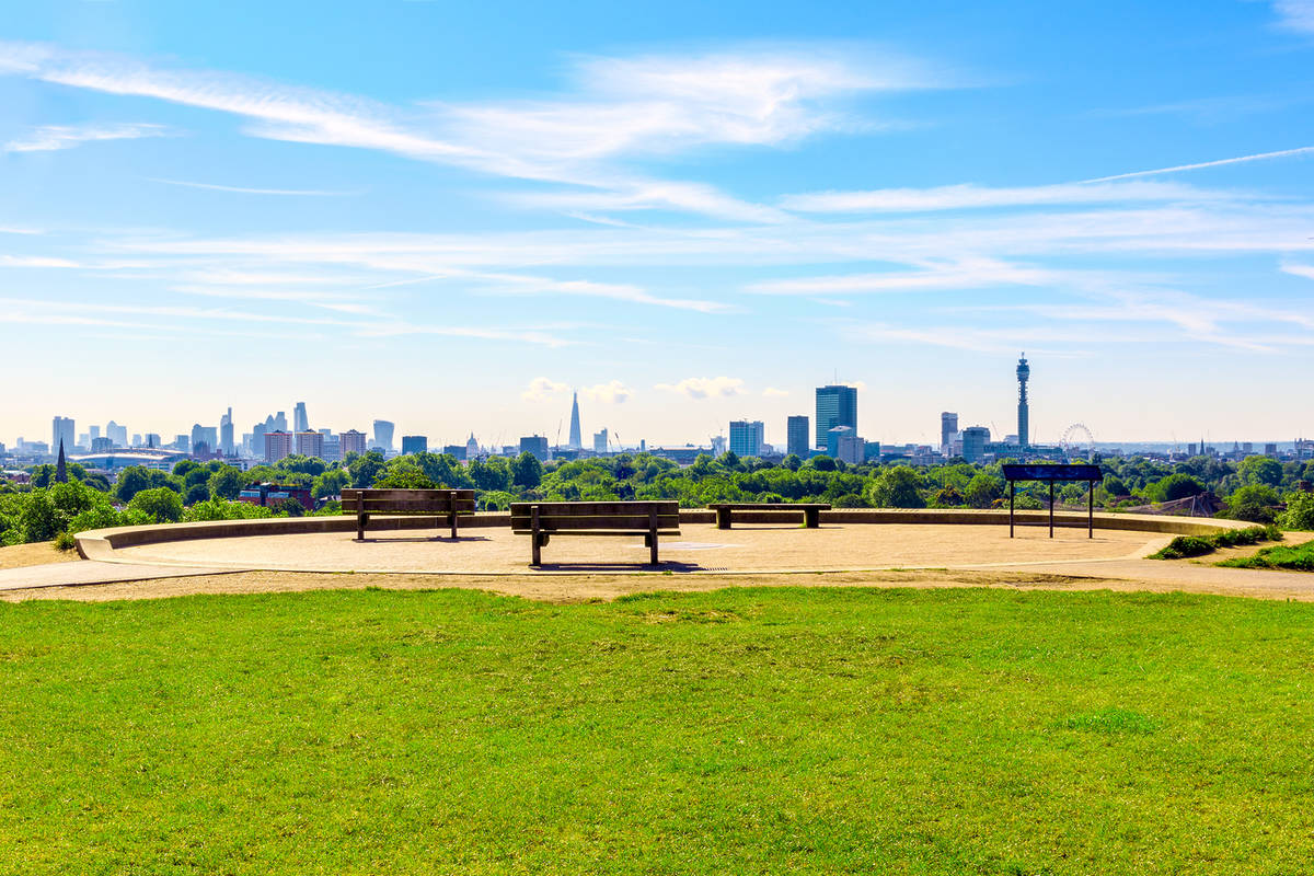 a summer's day in london as seen from a bench and a vantage point looking out across the city
