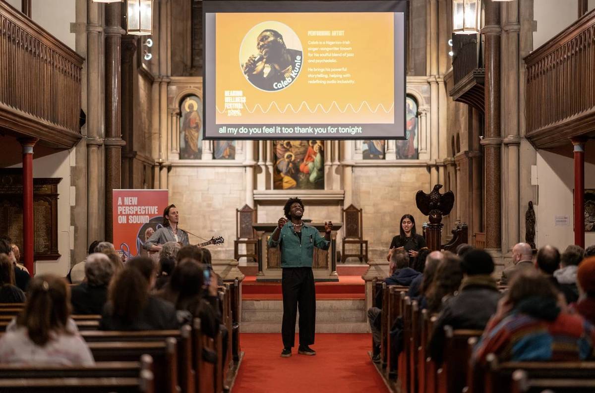 someone performing at an audio-inclusive gig in a church building