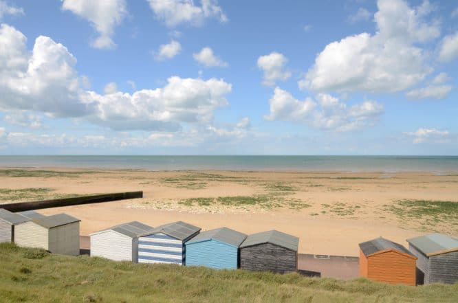 Sweeping sands at Minnis Bay in Kent, England