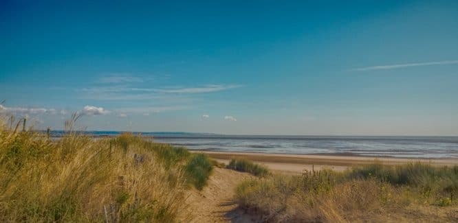 A swathe of sand and dunes at Greatstone Beach in England, one of the beaches near London in this roundup