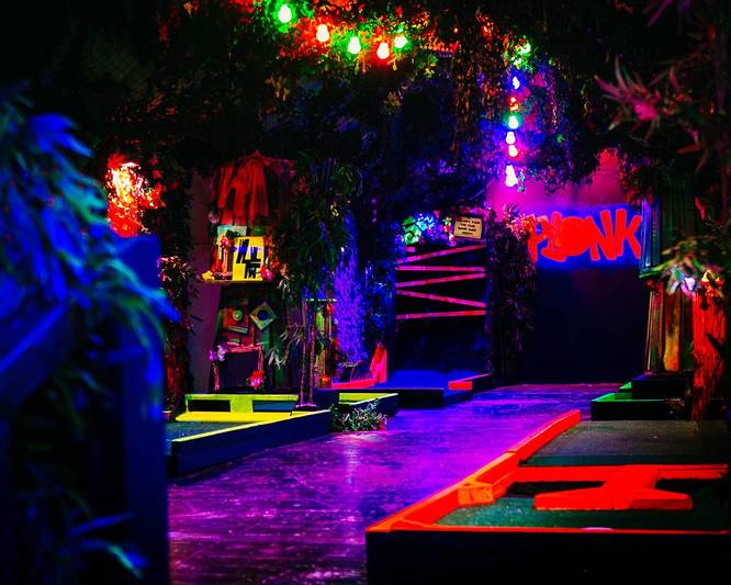 Inside Plonk - a neon decorated crazy golf venue