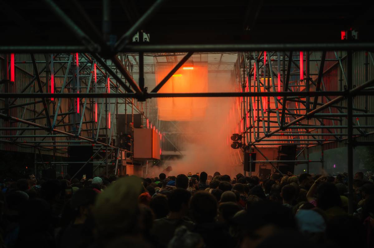 a massive crowd standing in front of a stage at rally festival