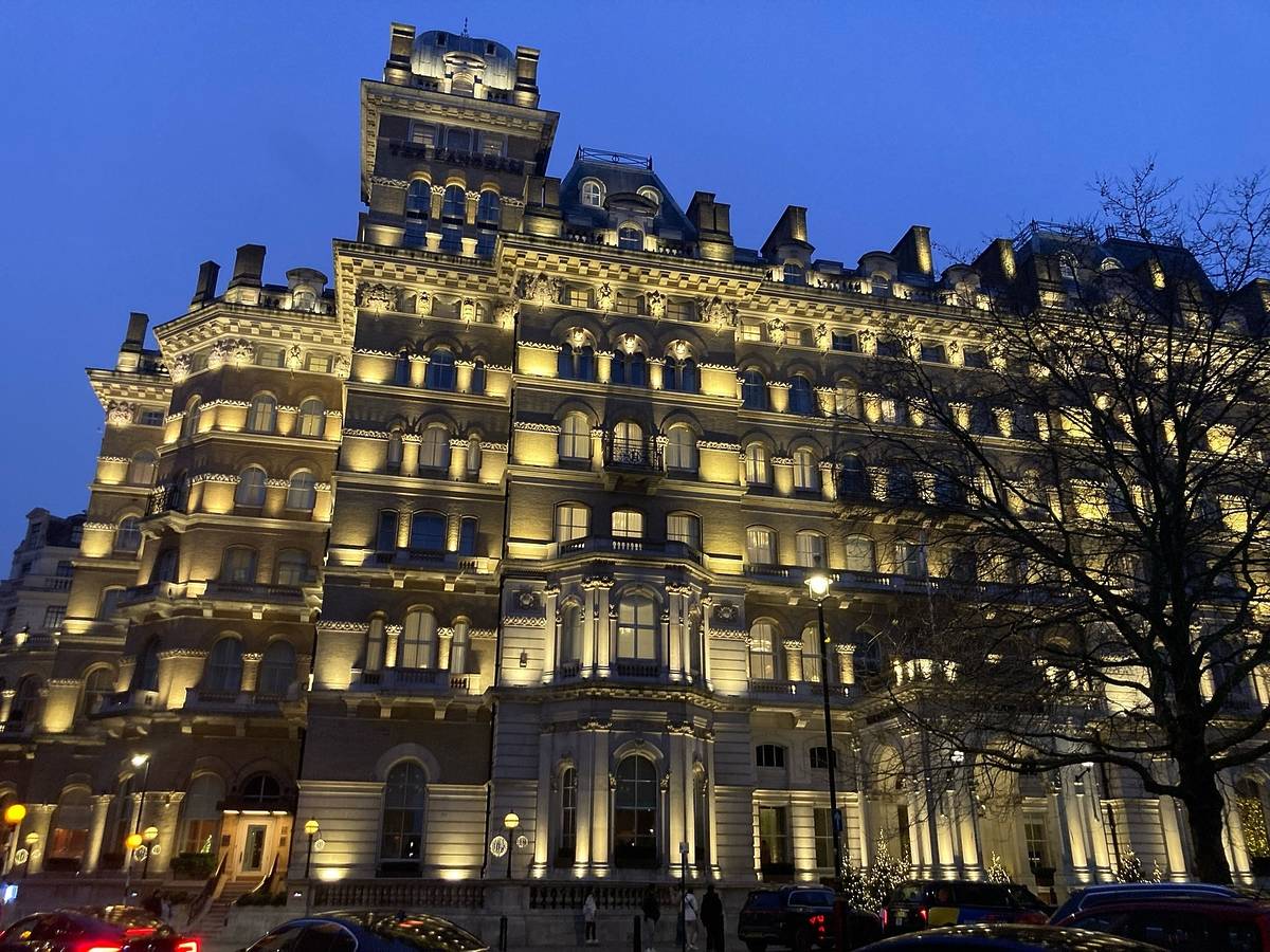 the langham hotel seen from outside at night with all the windows and lights lit up