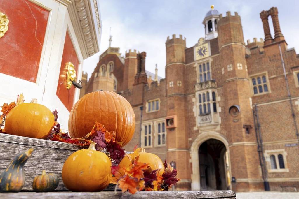 pumpkins and halloween decorations displayed in front of hampton court palace