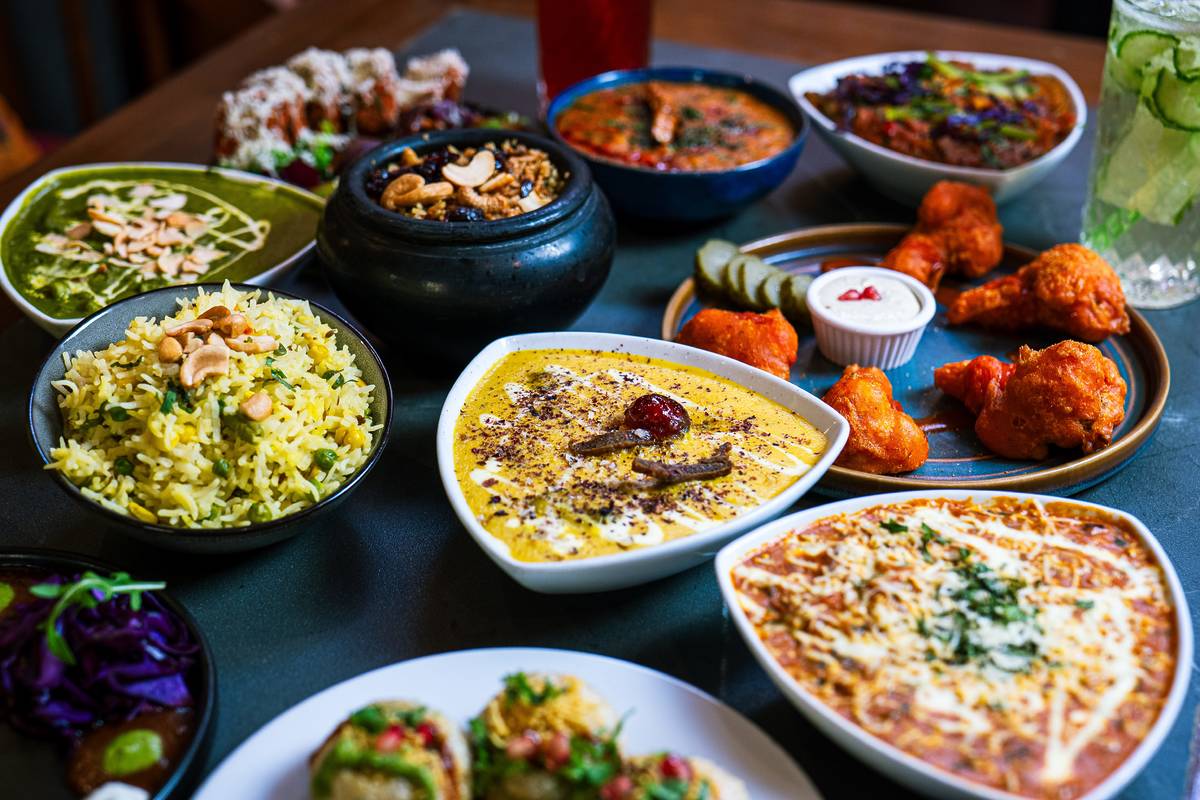 an array of indian food served at OmNom at Namaste
