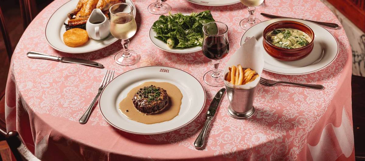 a table at brasserie zedel with food and place settings for multiple diners