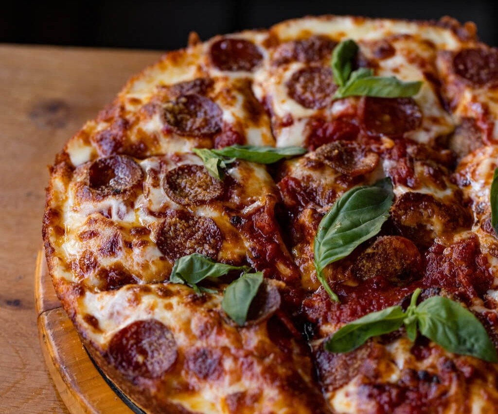 a london-style pizza from japes with oozy caramelised cheese and sausage and pepperoni