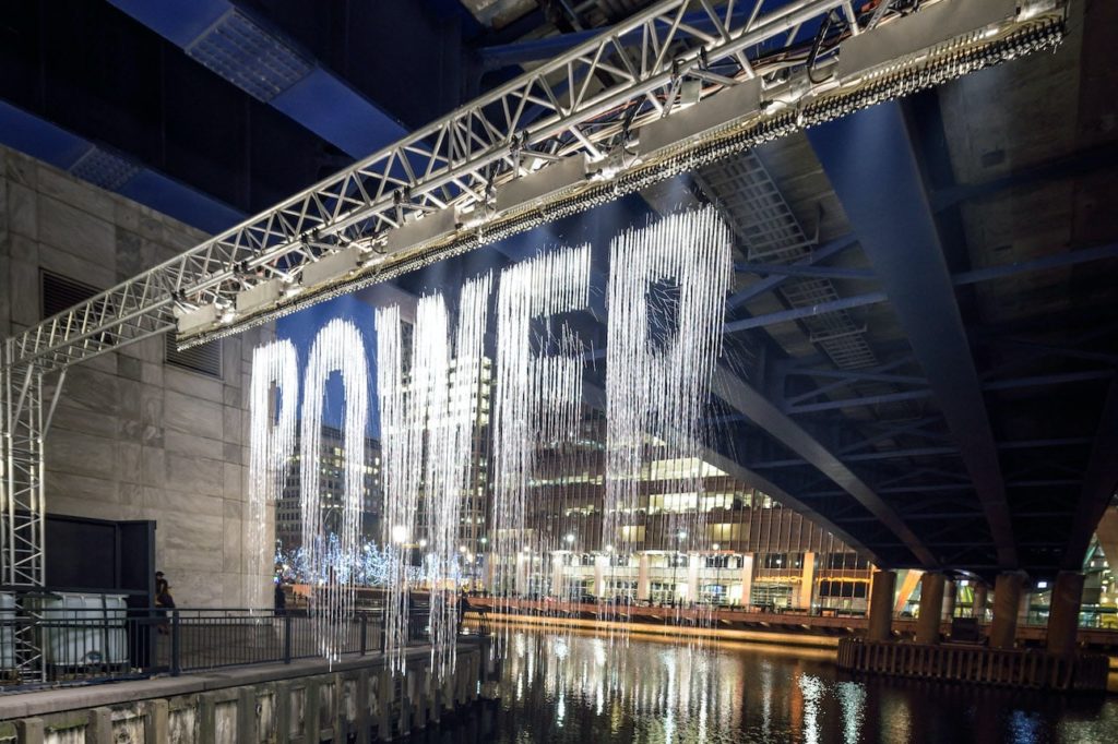 a light display that lights up falling droplets of water, displaying the word 'power'