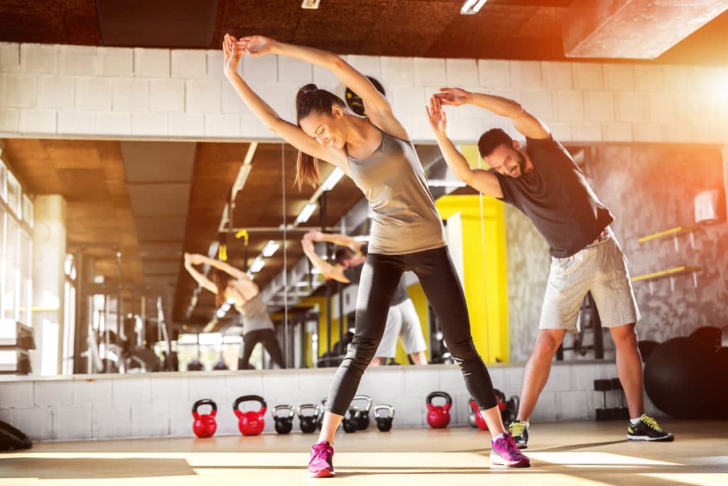 Two people exercising at a gym in London