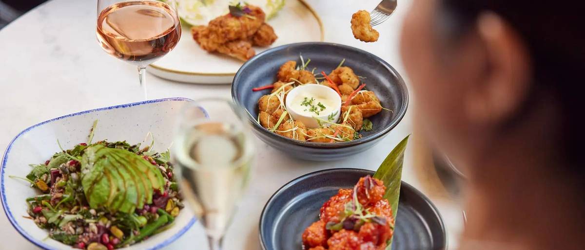 a table of brunch dishes and glasses of prosecco