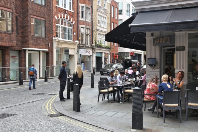 People enjoying themselves smoking shisha outside Drunch in Central London