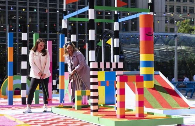 canary wharf summer two women playing minigolf
