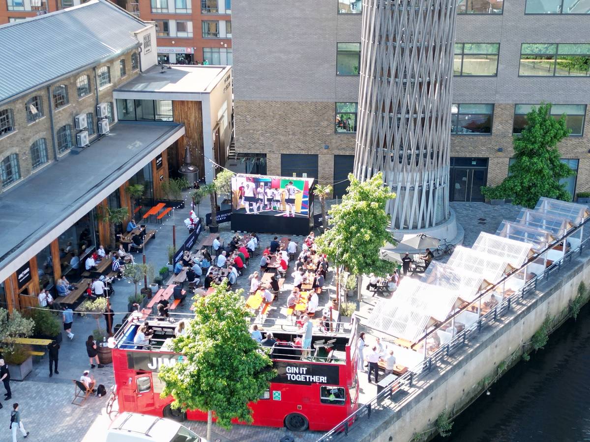 an outdoor viewing area between two buildings and the river thames